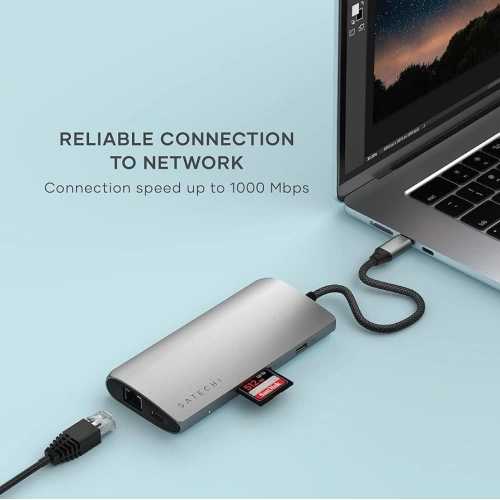 Satechi USB-C Multiport 8K adapter connected to a laptop, showcasing its functionality.
