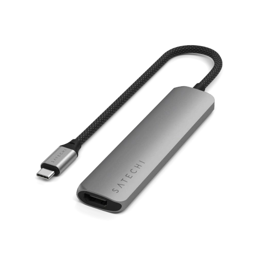 The Satechi HUB port set, including two USB-A ports and a card reader, against a white desk.